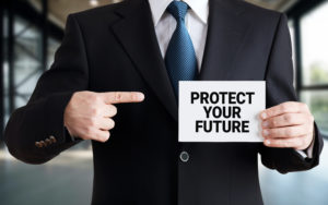 man in suit holding sign saying Protect Your Future