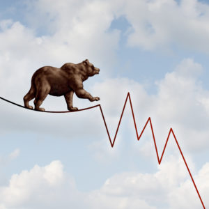 Bear market risk financial concept of bear balancing on a wire