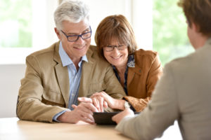 retirement aged couple meeting with financial advisor