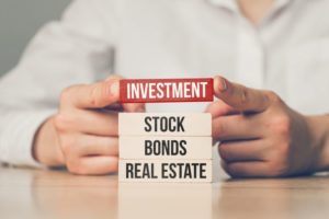 blocks with words: Investment, Stock, Bonds, Real Estate